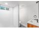 Modern bathroom with a tiled shower, sleek vanity, and gray tile flooring, showcasing contemporary design at 862 Pontiac St, Denver, CO 80220