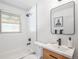 This home's bright bathroom features modern fixtures, a soaking tub, and ample natural light at 862 Pontiac St, Denver, CO 80220