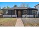 Charming home featuring a dark gray brick, well-manicured lawn, walkway, and attractive front yard landscaping at 862 Pontiac St, Denver, CO 80220