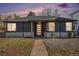Attractive home featuring gray brick, lawn, walkway, and attractive front yard landscaping at dusk at 862 Pontiac St, Denver, CO 80220