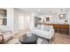 Bright and airy living room with a modern kitchen featuring stainless steel appliances and a stylish breakfast bar at 862 Pontiac St, Denver, CO 80220