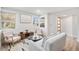 The naturally lit living room offers a comfortable area to relax and enjoy the view from large windows at 862 Pontiac St, Denver, CO 80220