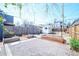 Backyard featuring a white shed, wooden fencing, garden beds, gravel, and a fire pit at 3735 Inca St, Denver, CO 80211