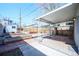 Relaxing backyard area with a covered patio, garden beds, gravel, and wooden fencing at 3735 Inca St, Denver, CO 80211