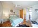 Cozy bedroom features a ceiling fan, hardwood floors, and a sliding barn door leading to a closet at 3735 Inca St, Denver, CO 80211