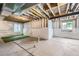 Unfinished basement showing open rafters, concrete foundation, and windows at 4433 N Picadilly Ct, Aurora, CO 80019