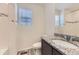 Bathroom with granite countertop, sink, decorative mirror, and wood-style flooring at 4433 N Picadilly Ct, Aurora, CO 80019