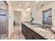 Bright bathroom with dual sinks, granite countertops, and a glass-enclosed shower, all designed for a luxurious experience at 4433 N Picadilly Ct, Aurora, CO 80019