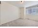 Well-lit bedroom offering neutral carpeting, a large window for natural light, and a closet at 4433 N Picadilly Ct, Aurora, CO 80019