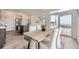 Open dining area with a modern table, chairs, and a large sliding glass door offering ample natural light and backyard views at 4433 N Picadilly Ct, Aurora, CO 80019