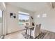 Bright dining area with a stylish table, chairs, and a large window offering natural light and neighborhood views at 4433 N Picadilly Ct, Aurora, CO 80019