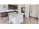 Well-lit kitchen featuring a large island, modern appliances, and stylish cabinetry, all enhanced by a neutral color palette at 4433 N Picadilly Ct, Aurora, CO 80019