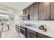 Modern kitchen featuring stainless steel appliances, white countertops and dark brown cabinets at 4433 N Picadilly Ct, Aurora, CO 80019