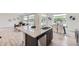 Modern kitchen featuring a large island with seating and stainless steel dishwasher at 4433 N Picadilly Ct, Aurora, CO 80019