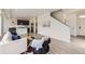 Inviting living room featuring an open-concept design, a kitchen, and comfortable seating, perfect for relaxation and entertaining at 4433 N Picadilly Ct, Aurora, CO 80019
