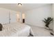 Spacious main bedroom with a view into the bathroom, soft carpeting, and a calming color scheme at 4433 N Picadilly Ct, Aurora, CO 80019