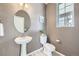 Stylish powder room with a pedestal sink and modern fixtures at 4433 N Picadilly Ct, Aurora, CO 80019