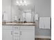 Bright bathroom features a double sink vanity and a large mirror at 3344 Evening Pl, Castle Rock, CO 80109