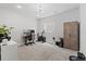 A carpeted office or workout space with a desk, exercise bike, and wooden cabinet at 3344 Evening Pl, Castle Rock, CO 80109