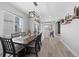 Elegant dining room featuring a farmhouse table, modern lighting, and seamlessly flows into a well-appointed kitchen at 3344 Evening Pl, Castle Rock, CO 80109