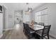 Elegant dining room featuring a farmhouse table, modern lighting, and large windows, perfect for entertaining and Gathering meals at 3344 Evening Pl, Castle Rock, CO 80109