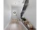 Bright foyer featuring wood floors, a modern staircase, and stylish decor, creating a welcoming entrance to the home at 3344 Evening Pl, Castle Rock, CO 80109