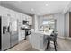 Stylish kitchen with stainless steel appliances, white cabinets, and an island with bar seating, perfect for casual dining at 3344 Evening Pl, Castle Rock, CO 80109