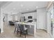 Open-concept kitchen with white cabinets, stainless steel appliances, and a seamless flow to the dining and living areas at 3344 Evening Pl, Castle Rock, CO 80109