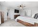 Bright main bedroom showcasing a king bed, wooden dresser, and ensuite bath access at 3344 Evening Pl, Castle Rock, CO 80109