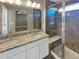 Double vanity bathroom with large shower and granite top at 4723 Joplin St, Denver, CO 80239