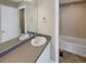 Clean bathroom with a bathtub and double vanity at 4723 Joplin St, Denver, CO 80239