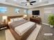 Virtually staged main bedroom with ceiling fan and large bed at 4723 Joplin St, Denver, CO 80239