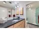 Bright bathroom with modern vanity, a large mirror and a separate shower cabin with white tile walls at 8392 Niwot Meadow Farm Rd, Niwot, CO 80503