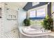 Serene bathroom featuring a soaking tub, walk-in shower, and views of the private backyard at 8392 Niwot Meadow Farm Rd, Niwot, CO 80503