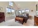 Calm bedroom with vaulted ceilings, large windows offering lovely backyard views, and cozy carpet at 8392 Niwot Meadow Farm Rd, Niwot, CO 80503
