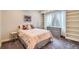 Cozy bedroom with shelves, a comfortable bed, and a large window at 8392 Niwot Meadow Farm Rd, Niwot, CO 80503