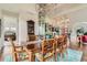 Spacious dining room with a large wooden table, seating for eight, and open views into the kitchen and living room at 8392 Niwot Meadow Farm Rd, Niwot, CO 80503