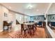 Open-concept dining room, living room and staircase boasts hardwood floors and a light blue accent wall at 8392 Niwot Meadow Farm Rd, Niwot, CO 80503
