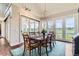 Elegant dining room with large windows, stylish lighting, and a spacious table set for a memorable meal at 8392 Niwot Meadow Farm Rd, Niwot, CO 80503