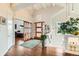 Bright foyer with wood floors, vaulted ceilings, and a stylish light fixture, leading to an office and living space at 8392 Niwot Meadow Farm Rd, Niwot, CO 80503