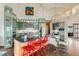 Stylish open-concept kitchen with an island, bar seating, modern appliances, and ample counter space for cooking and gathering at 8392 Niwot Meadow Farm Rd, Niwot, CO 80503