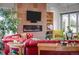 Inviting living room features a sleek fireplace, large TV, and comfortable red leather seating at 8392 Niwot Meadow Farm Rd, Niwot, CO 80503