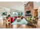 Bright living room with high ceilings, stone fireplace, large windows, and comfortable seating, creating an open and airy feel at 8392 Niwot Meadow Farm Rd, Niwot, CO 80503