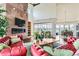 Expansive living room with vaulted ceilings, a stone fireplace, and comfortable seating, with views of the outdoor landscape at 8392 Niwot Meadow Farm Rd, Niwot, CO 80503