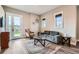 Cozy living room with comfortable seating, natural light, and a view of the outdoors through glass patio doors at 8392 Niwot Meadow Farm Rd, Niwot, CO 80503