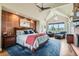 Inviting main bedroom with a stone accent wall, cozy seating area, and views of the property at 8392 Niwot Meadow Farm Rd, Niwot, CO 80503