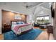 Bright main bedroom with high ceilings, wood floors, and a relaxing seating area at 8392 Niwot Meadow Farm Rd, Niwot, CO 80503
