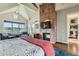 Bright and spacious main bedroom with a fireplace, seating area, and view of the outside at 8392 Niwot Meadow Farm Rd, Niwot, CO 80503