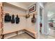 Welcoming mudroom features a built-in bench, storage, and coat hooks for organization at 8392 Niwot Meadow Farm Rd, Niwot, CO 80503