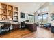Spacious office with wood floors, built-in shelving, large windows, and ample natural light at 8392 Niwot Meadow Farm Rd, Niwot, CO 80503